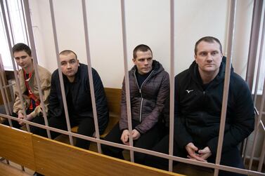 Four Ukrainian sailors sit in a Moscow courtroom, among 24 people detained by Russia since it intercepted three Ukrainian ships in the Kerch Strait in November AP 