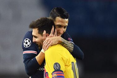 Paris Saint-Germain's Argentinian midfielder Angel Di Maria hugs Barcelona's Argentinian forward Lionel Messi. AFP