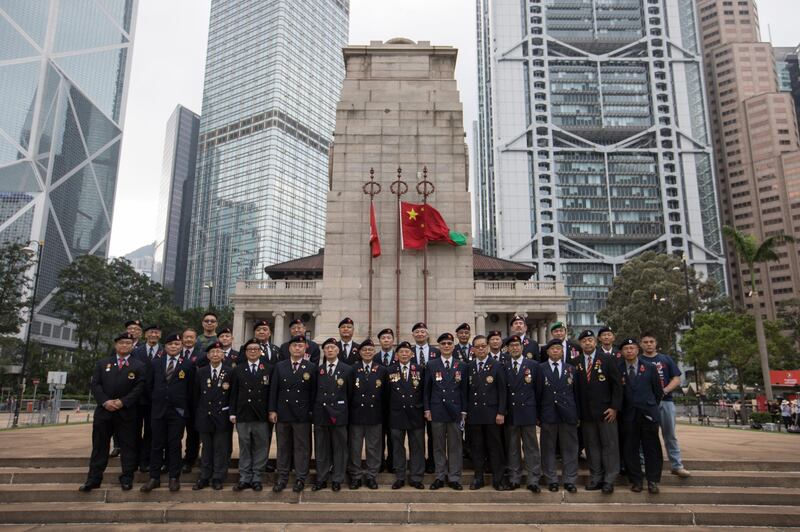 Hong Kong veterans pose for a photograph in front of the Cenotaph in Hong Kong. EPA