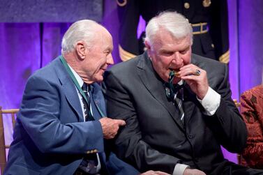 (FILE)- California Hall of Fame inductee US Air Force General Chuck Yeager (L) looks on as football icon John Madden (R) bites his Hall of Fame medal during the induction ceremony for The California Museum's 'California Hall of Fame' in Sacramento, California, USA, 01 December 2009 (reissued 28 December 2021).  John Madden, legendary NFL football coach and broadcaster, dies at age 85.  Madden passed away unexpectedly, according to CNN.   EPA/PETER DASILVA  . 