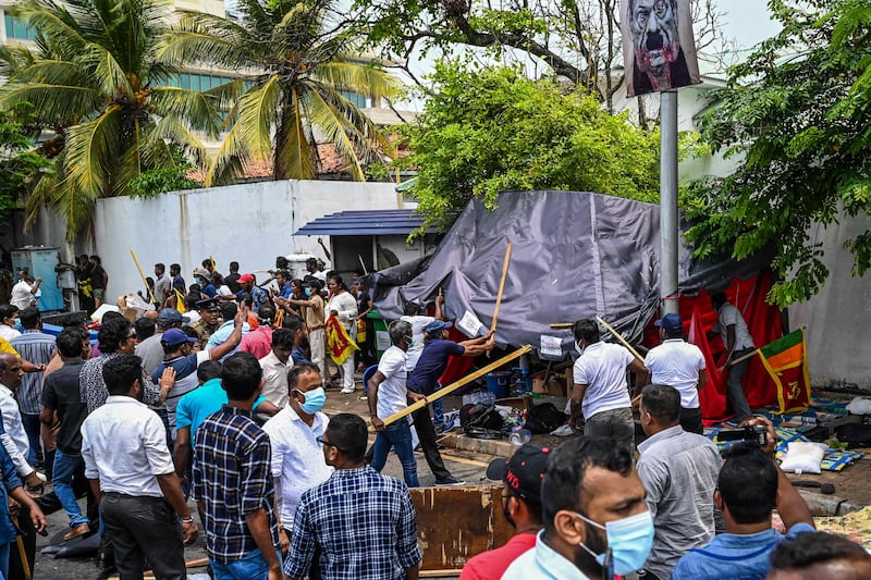 Demonstrators and government supporters clash outside the official residence of Mahinda Rajapaksa, 76, who offered his resignation to his younger brother, President Gotabaya Rajapaksa. AFP