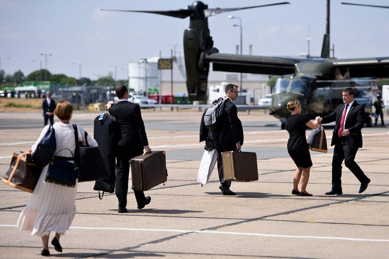 US first lady Melania Trump's chief of staff Lindsay Reynolds (L) follows luggage to helicopters at London Stansted Airport. AFP