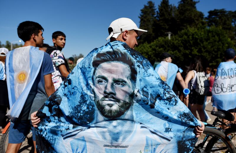 An Argentina fan with a flag of Lionel Messi at the World Cup victory parade in Buenos Aires. Reuters
