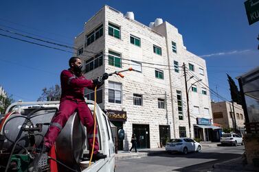 epa08397683 A Jordanian worker of Amman City hall disinfects a street of al-Weibdeh area in Amman, Jordan, 02 May 2020. After some seven weeks of lockdown, then full curfews on weekends, hairdressers, textile, shoes and some other businesses of Jordan were allowed on the last week of April to reopen their shops, and work under the conditions of wearing protective masks and applying safe distance rules. According to the Jordanian Health Ministry, the country has seen zero new cases for the past four days, the only two to three cases registered daily in this period were at the border crossing, as truck drivers tested positive and were taken into quarantine and treatment. EPA/ANDRE PAIN