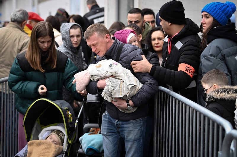 Ukrainians queue outside a refugee centre in Paris. AFP
