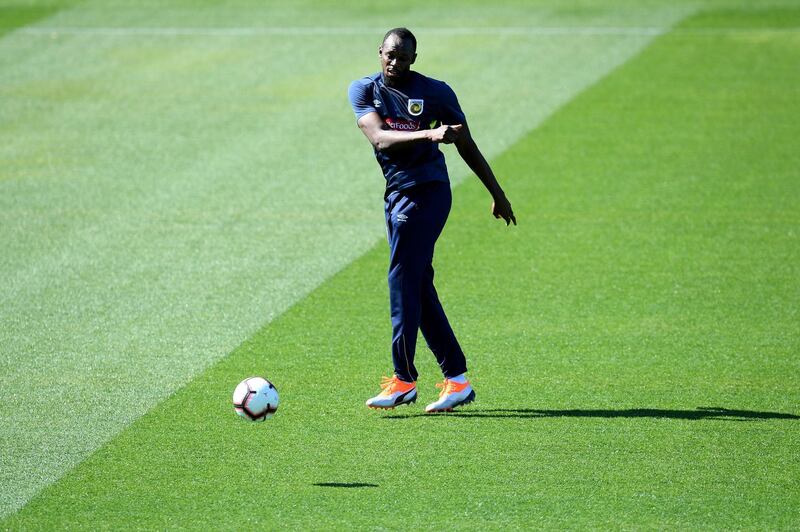 Usain Bolt passes the ball as he is put through his paces. EPA