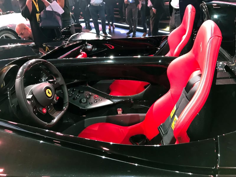 The Ferrari Monza SP2 is displayed in Maranello, Italy, Tuesday, Sept. 18, 2018. Sportscar maker Ferrari has unveiled two updated versions of its classic open-top "barchetta" racing model as it briefs investors on a new five-year business plan. Nicolo Boari, the head of product marketing, said Tuesday that the Ferrari Monza SP1 and SP2 are "the most powerful ever in Ferrari history," with an 810 horsepower engine able to reach 100 kilometers per hour (62 mph) in 2.9 seconds. (AP Photo/Collen Barry)