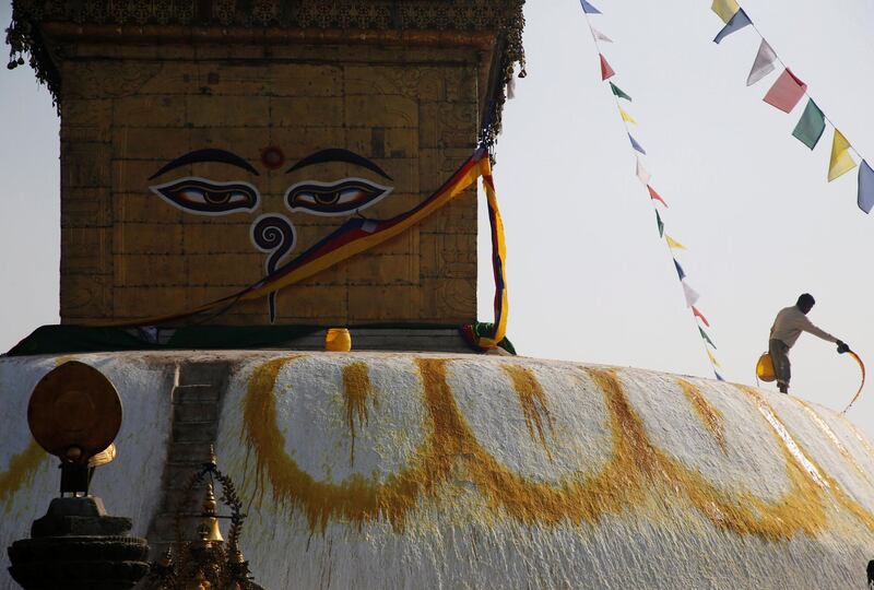 A man splashes paint on the dome of Swayambhunath Stupa in Kathmandu, Nepal. Navesh Chitrakar / Reuters
