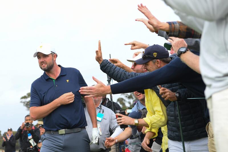 Marc Leishman celebrates with fans after his shot on the 18th hole. Getty