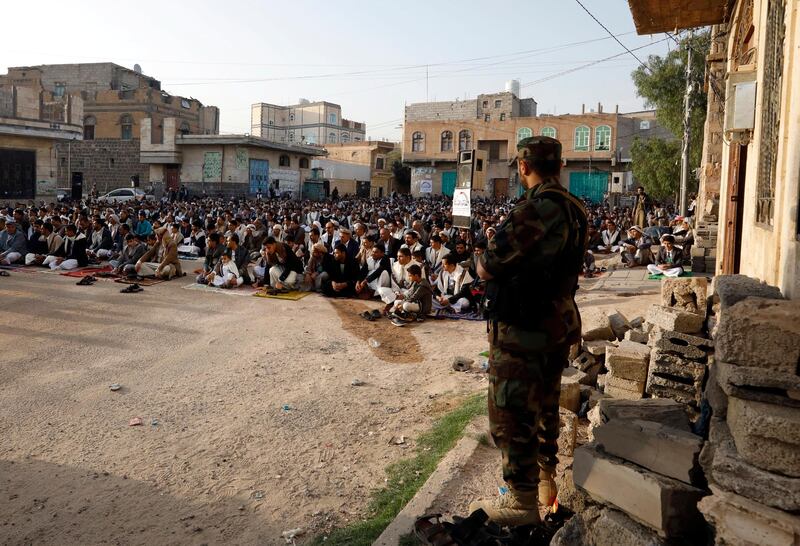 A pro-Houthi soldier keeps watch as worshippers attend Eid Al Fitr prayers in Sanaa. EPA