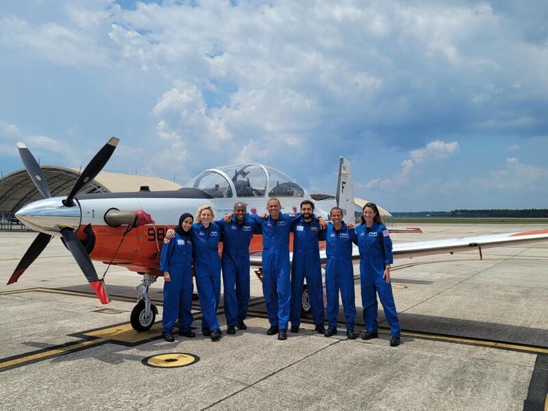 Nora Al Matrooshi, left, and Mohammed Al Mulla, third from right, completed training on the T-6A aircraft. Photo: Anil Menon Instagram