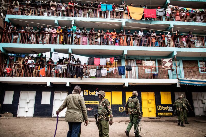 Residents look on as Kenyan Administration Police officers patrol in the Mathare Slum of Nairobi during protests against Kenya's national election results.
Marco Longari / AFP