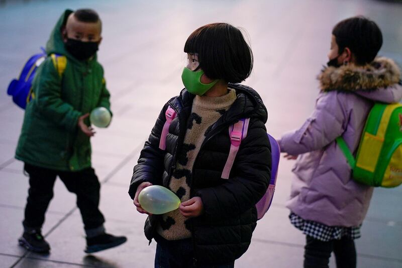 FILE PHOTO: Children wearing face masks are seen at Shanghai railway station in Shanghai, China March 5, 2020. REUTERS/Aly Song/File Photo