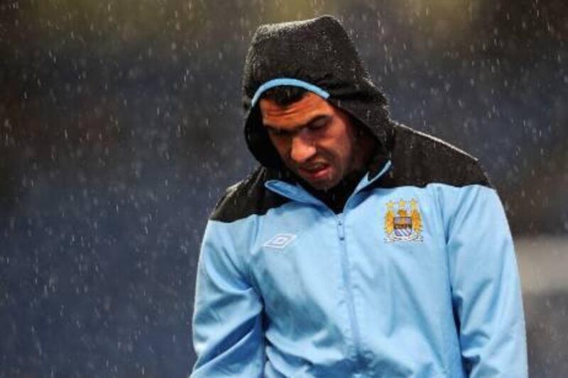 MANCHESTER, ENGLAND - SEPTEMBER 21: Carlos Tevez of Manchester City warms up in the rain before the Carling Cup Third Round match between Manchester City and Birmingham City at the Etihad Stadium on September 21, 2011 in Manchester, England.  (Photo by Michael Regan/Getty Images)