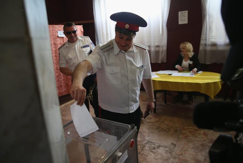 An officer casts his vote in eastern Ukraine’s independence referendum on May 11, 2014 in Slovyansk, Ukraine. John Moore/Getty Images