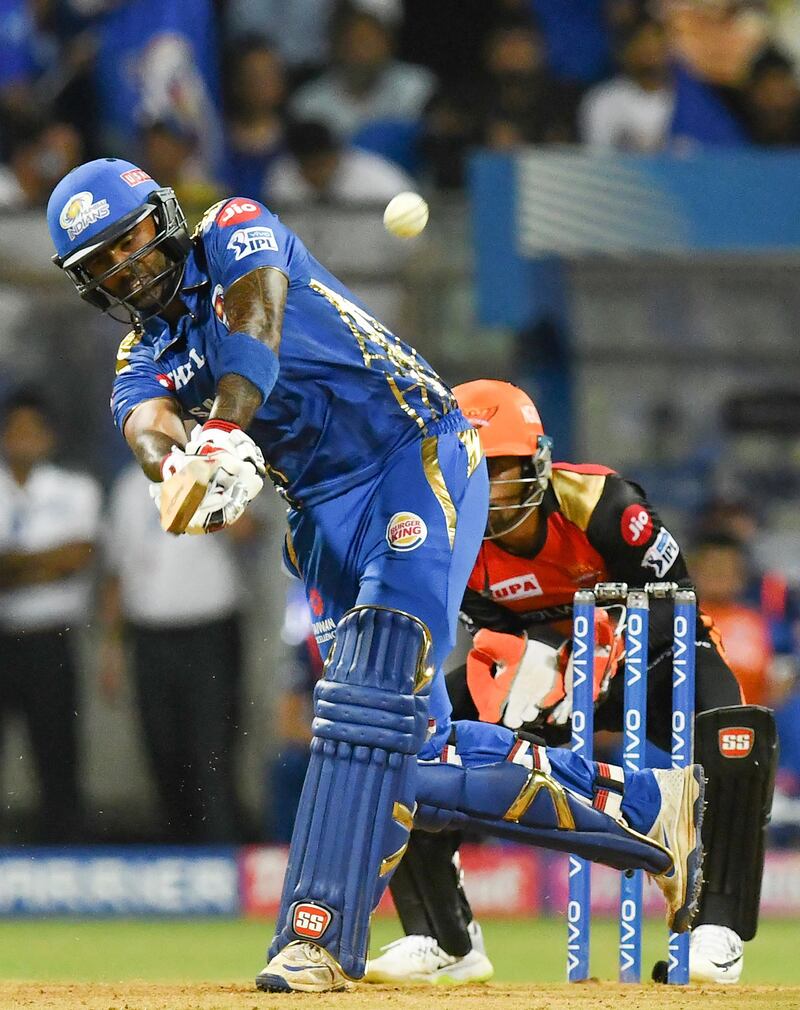 Mumbai Indians cricketer Suryakumar Yadav (L) plays a shot as Sunrisers Hyderabad wicketkeeper Wriddhiman Saha looks on during the 2019 Indian Premier League (IPL) Twenty20 cricket match between Mumbai Indians and Sunrisers Hyderabad at the The Wankhede Stadium cricket stadium in Mumbai on May 2, 2019. (Photo by Indranil MUKHERJEE / AFP) / ----IMAGE RESTRICTED TO EDITORIAL USE - STRICTLY NO COMMERCIAL USE----- / GETTYOUT
