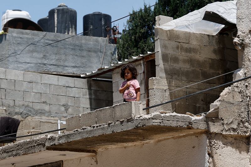 A child stands in a damaged building after an Israeli military operation at the Jenin refugee camp, in the occupied West Bank. Reuters