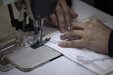 A worker sews a protective mask at the National Police clothing factory in Bogota, Colombia, on Saturday, March 28, 2020. Colombia has reported nearly 500 confirmed cases of coronavirus as the government of President Ivan Duque closed borders, suspended incoming flights and imposed a three-week lockdown to try to curb the spread. Photographer: Ivan Valencia/Bloomberg