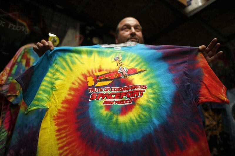 Jeff Dukatt displays a tie-dyed spaceport T-shirt he made at his store in Truth or Consequences, New Mexico. While it’s not clear what the economic impact will be, many agree that Spaceport America should inject new energy into the town. Lucy Nicholson / Reuters