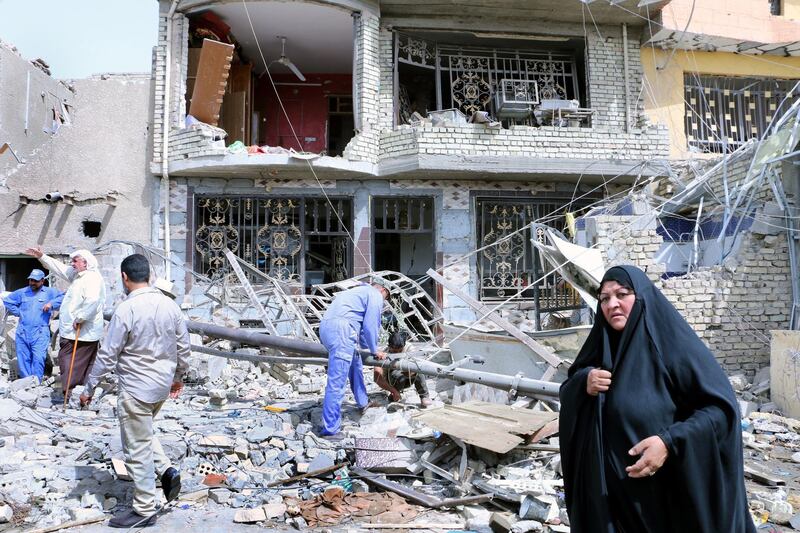 epaselect epa06790630 Iraqis gather at the explosion location at an arms depot in Baghdad's Sadr city, Iraq, 07 June 2018. At least 18 people were killed and dozens wounded after an arms depot belonging to Iraqi Shiite military group Saraya al-Salam exploded in the Sadr City district of the Iraqi capital late on 06 June 2018, security and medical sources said.  EPA/AHMED ALI