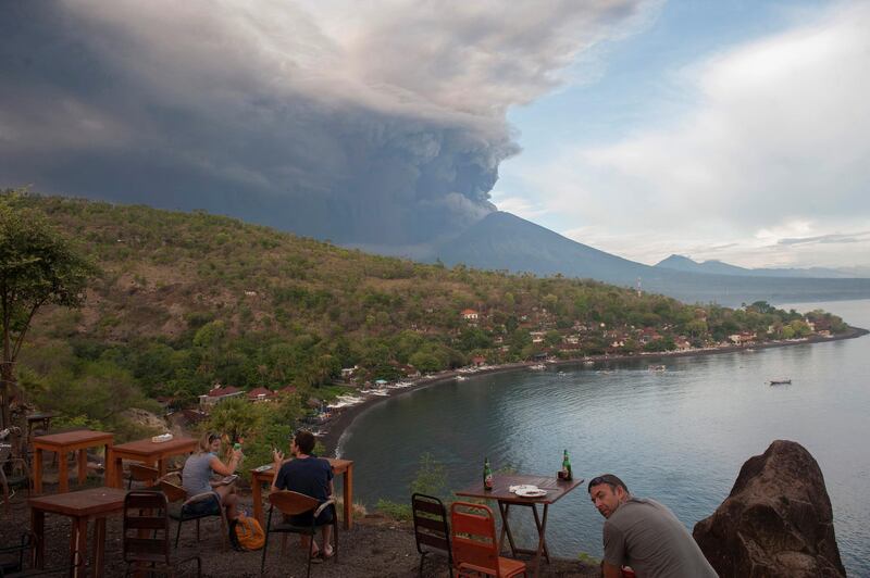 Tourists watch the eruption of Mount Agung at a restaurant on Jemeluk Beach, Amed, Karangasem, Bali. Antara Foto / Nyoman Budhiana / via Reuters