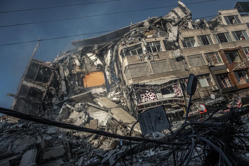 Smoke rises from the rubble of Al-Shorouk Tower in Gaza city. Getty Images