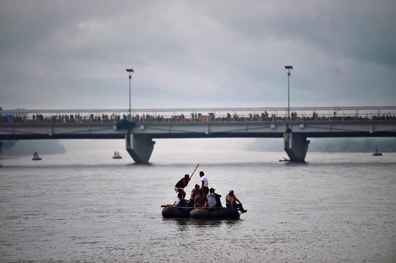 Honduran migrants heading in a caravan to the US use a makeshift raft to cross the Suchiate River, the natural border between Guatemala and Mexico, in Ciudad Hidalgo, Chiapas state, Mexico. AFP