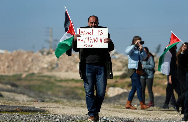 A protester carries a sign during a demonstration  against the newly-opened Route 4370 in the occupied West Bank. AFP