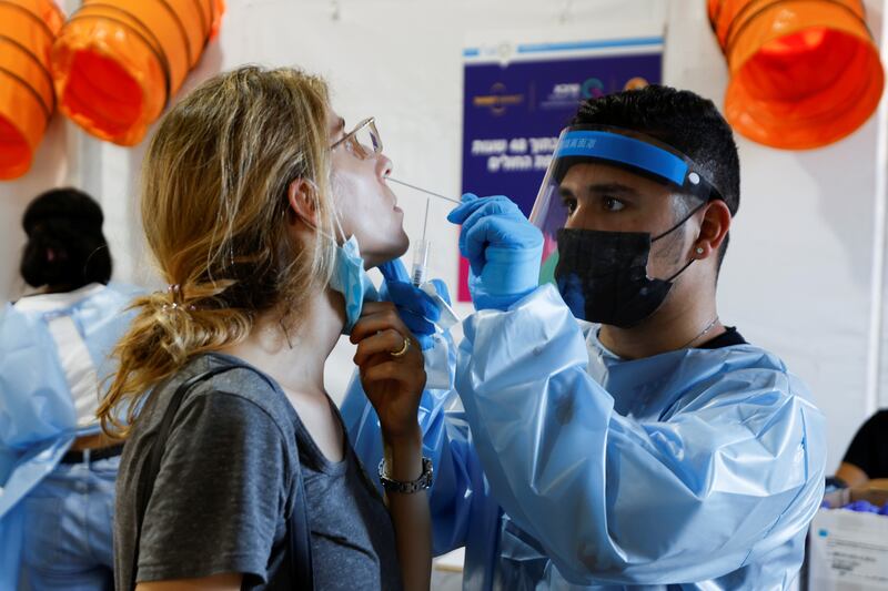 A health worker tests a person for Covid-19 at Rabin Square in Tel Aviv, Israel.