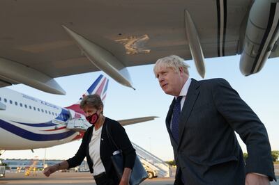 Britain's Prime Minister Boris Johnson with Dame Barbara Janet Woodward, Permanent Representative of the UK to the UN, as he lands in New York's JFK airport on Monday. PA