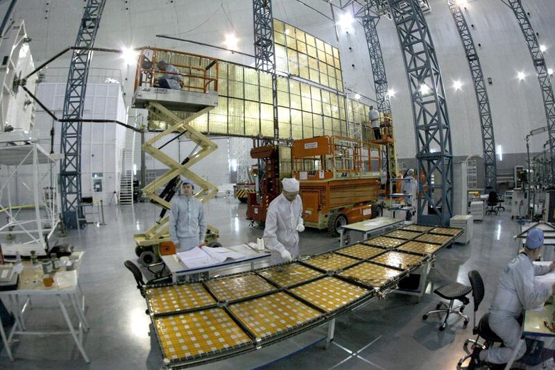 Specialists of the “Kvant” (Quantum) research-and-production enterprise work on a solar battery for the Express AM6 new generation geostationary telecommunications heavy satellite at the Reshetnev Information Satellite Systems facility in Zheleznogorsk. Ilya Naymushin / Reuters