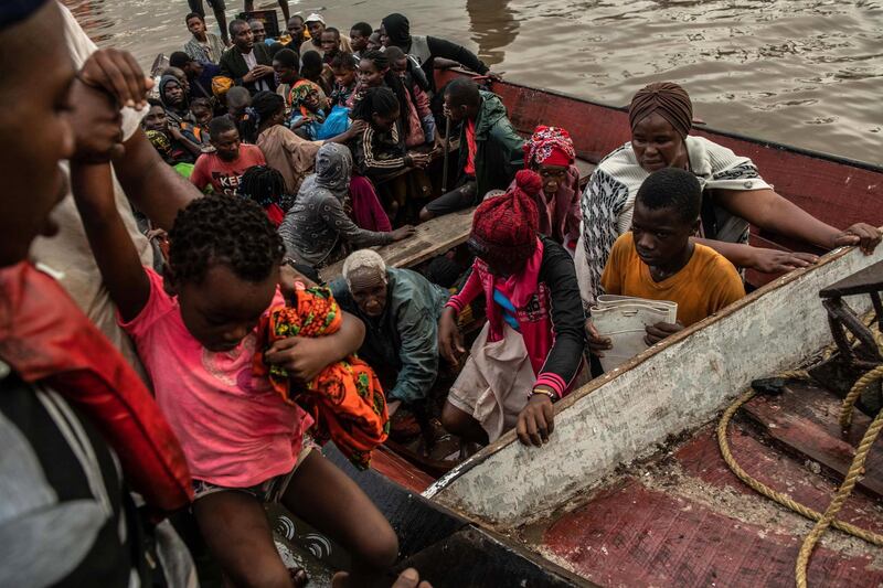 People from the town of Buzi unload from a boat at Beira Port. Getty Images