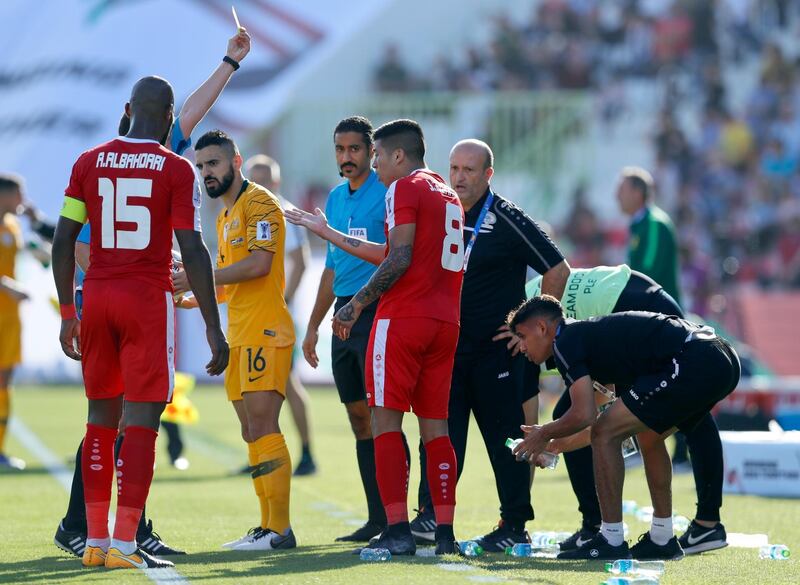 Palestine's Jonathan Zorrilla gets a yellow card. AP Photo