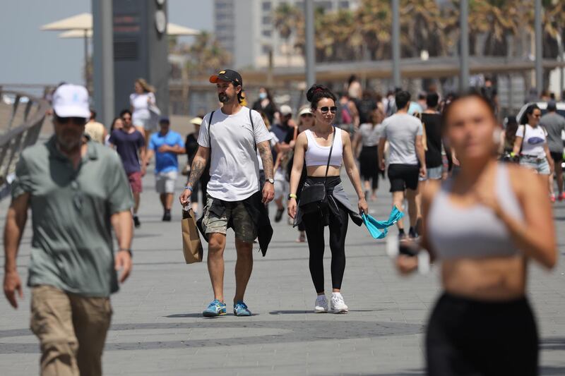 People without face masks enjoy the weather on the beach of Tel Aviv. EPA