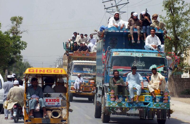 Pakistani civilians fleeing from a military operation in North Waziristan arrive in Bannu district on June 18, 2014. More than 1,000 vehicles arrived June 18 in the town of Bannu, a traditional haven for those fleeing violence in restive North Waziristan. Karim Ullah/AFP Photo

