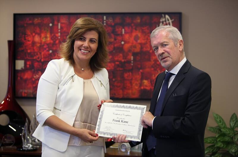 Elissar Farah Antonios, the chief executive of Citi’s UAE arm, left, presents to Frank Kane the Citibank Journalistic Excellence Award at the bank’s Dubai headquarters. Ravindranath K / The National