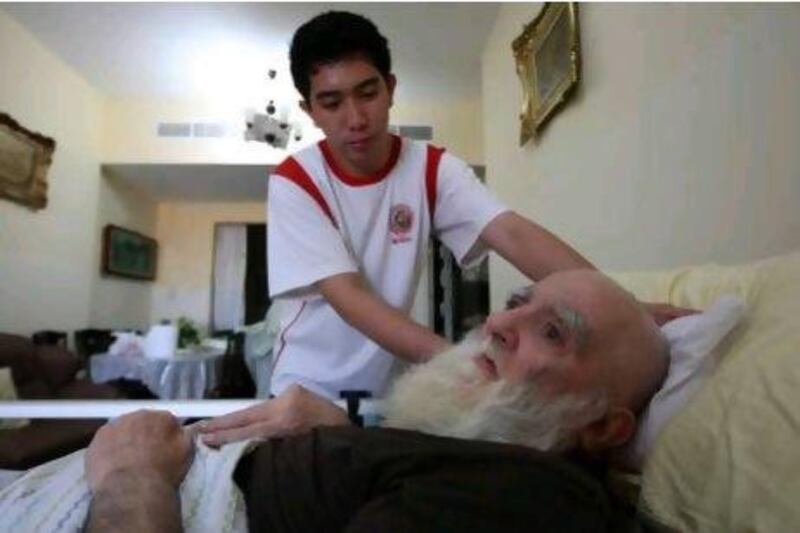 Jeruy Greg working as a nurse helping Mohammed Kazim Habib at his home in Ajman.