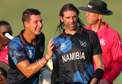 Namibia's David Wiese, centre, celebrates with JJ Smit as Namibia beat the Netherlands in Abu Dhabi. Chris Whiteoak / The National