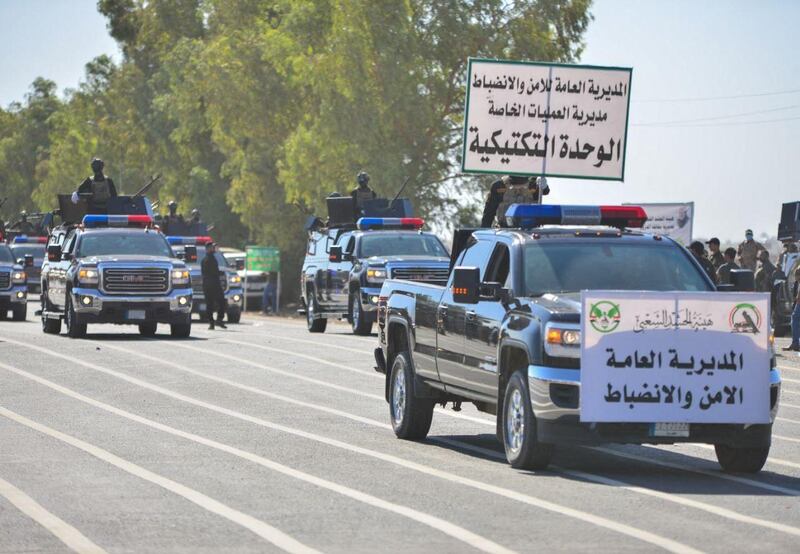 Members of Iraq's Popular Mobilisation Forces take part in a parade to mark the seventh anniversary of the organisation's founding at Camp Ashraf in Diyala province. AFP