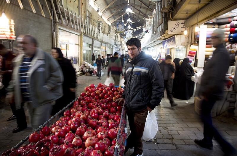 An Iranian vendor sells pomegranates at Tehran's main bazaar on January 2. Maryam Rahmanian for The National