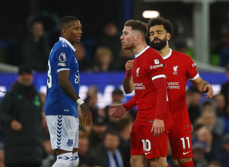 Liverpool midfielder Alexis Mac Allister argues with Everton full-back Ashley Young. Reuters