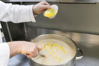 DUBAI, UNITED ARAB EMIRATES - MAY 10, 2018. 

Executive Chef, Nasser Ibrahim, adds ghee to the harees and stirs it at Seven Sands restaurant in The Beach.



(Photo by Reem Mohammed/The National)

Reporter: 
Section: WK