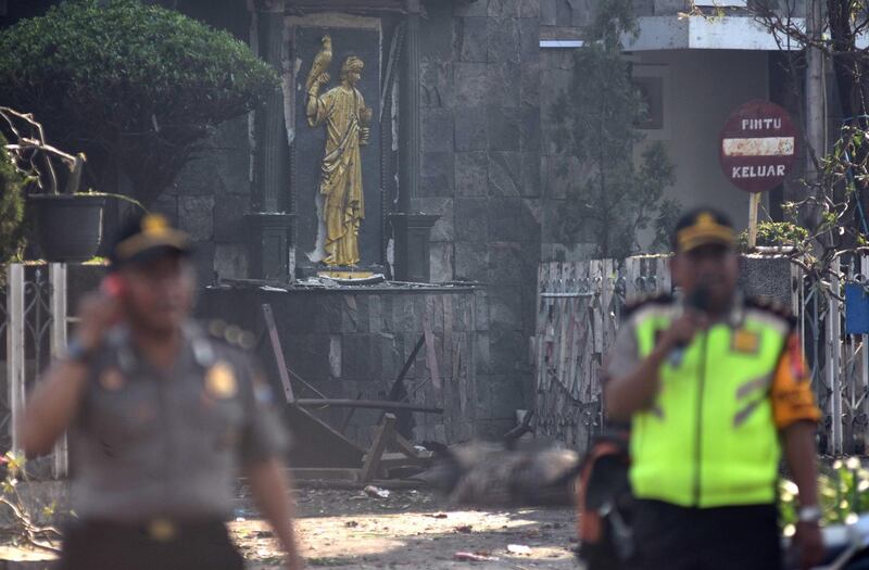 Police are seen outside the Immaculate Santa Maria Catholic Church following a blast, in Surabaya, East Java, Indonesia. Reuters