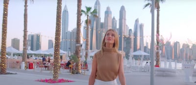 The skyline of Dubai Marina can be glimpsed behind Rosie Huntington-Whiteley in the second episode of her new show, 'About Face'. YouTube