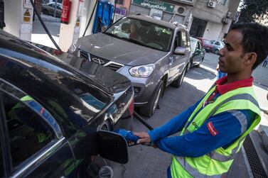 A worker fuels a vehicle at a petrol station in Cairo earlier this month. Egypt lowered domestic fuel prices, as it begins linking energy prices to international markets as part of an IMF-backed pricing mechanism. EPA