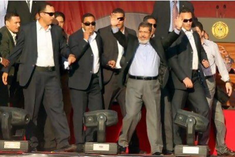 Egypt's president-elect Mohammed Morsi greets the crowd at Tahrir Square Friday. He will be officially sworn in as president Saturday.