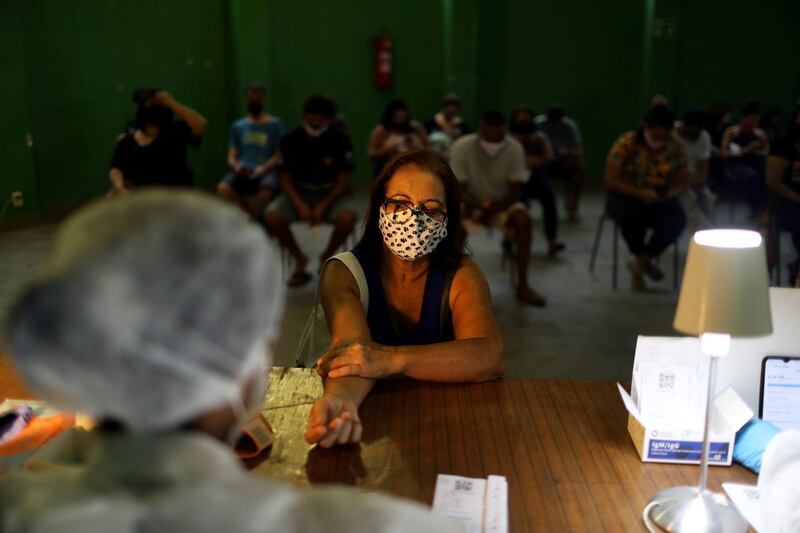 A nurse takes a blood sample from a woman for a test with the help of 'Dados do Bem' app, at the Santa Marta slum in Rio de Janeiro, Brazil. Reuters