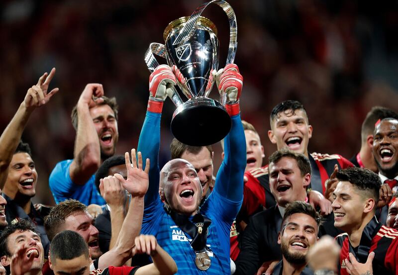 Atlanta United goalkeeper Brad Guzan hoists the trophy. AP Photo