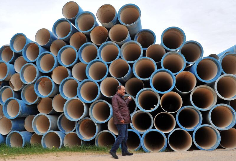 Mahmud al-Rammah shows water pipes waiting to be installed at the Zentan water pumping station in Libya. AFP
