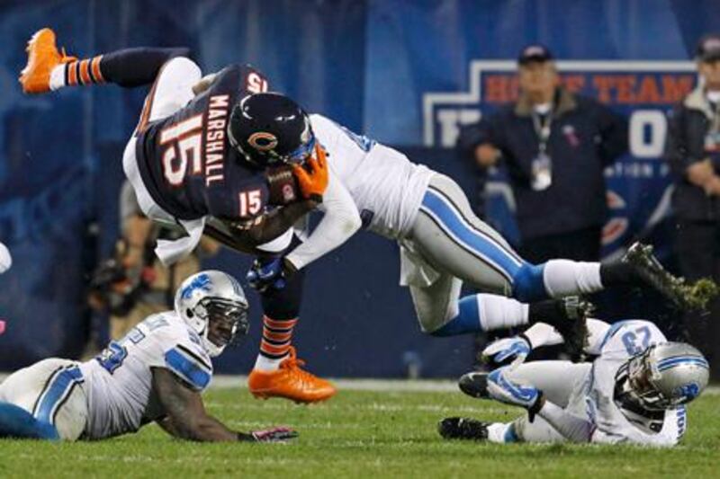 Chicago Bears wide receiver Brandon Marshall is tackled by Detroit's Amari Spievey